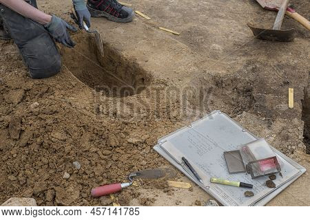 Archaeologist Kneeling At An Excavation In Erritsø Of A Viking Settlement, Erritsø, Denmark, June 15