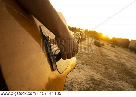 Guitar And Sunset. Playing Acoustic Guitar During Sunset. Playing Music During Sunset. Enjoying The 