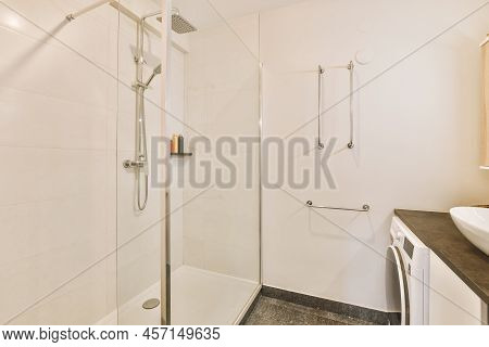 Contemporary Bathroom With Bathtub And Glass Shower Cabin With Light Tile And White Ceiling
