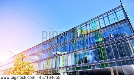 Modern Office Building With Glass Facade On A Clear Sky Background. Transparent Glass Wall Of Office