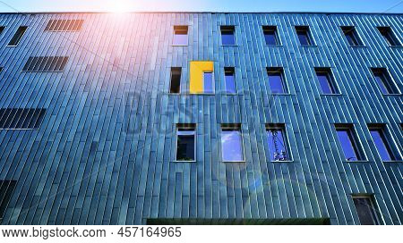 Fragment Of Modern Urban Geometry. Walls  Office Building Made Of Steel And Glass. Bright Sunny Day 