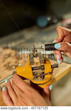 Woman Using Power Working Grinder Machine, Female Hand Grinds A Metal Nuts