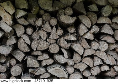 Pile Stacked Natural Sawn Wooden Logs Background. Background Of Birch Logs, Stacked On Top Of Each O