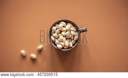 Flat Lay, Pistachios In A Plate On A Colored Background.