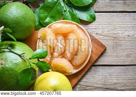 Pomelo Fruit On Wooden Plate  Background, Fresh Green Pomelo Peeled And Leaf Frome Pomelo Tree , Pum