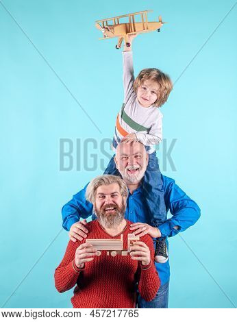 Men Generation: Grandfather Father And Grandson Are Hugging Looking At Camera And Smiling.