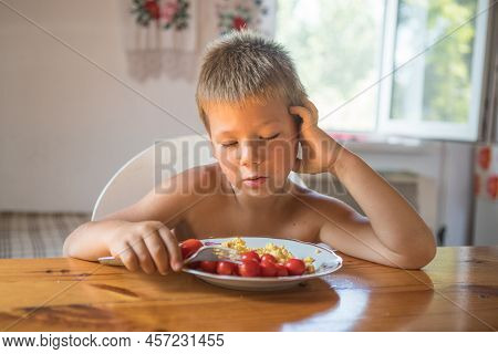 Blond Child In Domestic Kitchen Eat Healthy Food, Organic Vegan Fritatta  With Vegetables.