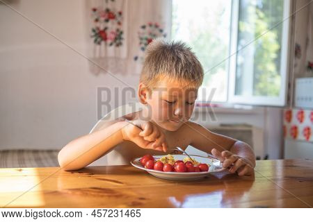 Blond Child In Domestic Kitchen Eat Healthy Food, Organic Vegan Fritatta  With Vegetables.