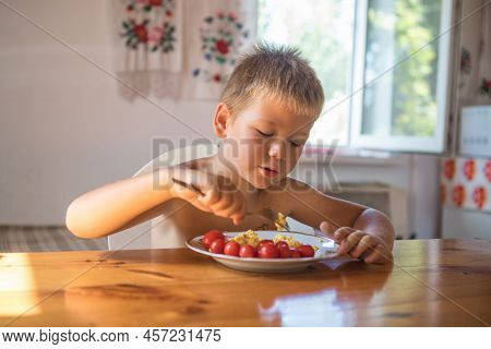 Blond Child In Domestic Kitchen Eat Healthy Food, Organic Vegan Fritatta  With Vegetables.