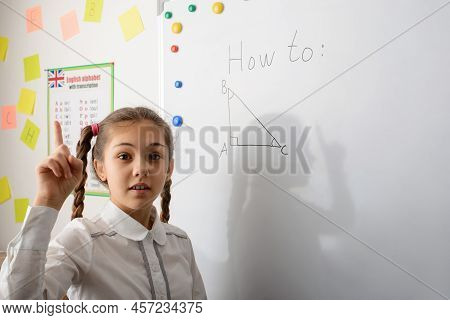 Little Excited Girl Pointing Finger Up And Ready To Tell Correct Answer To The Exercise, Knows Pytha