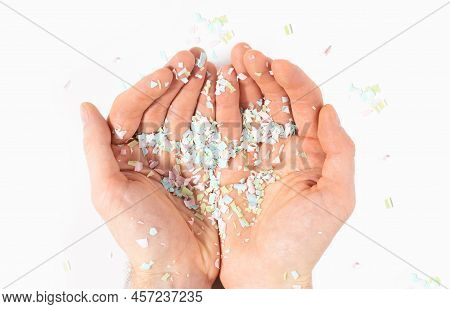 Shot Of Microplastics Lay On People Hand. Concept Of Water Pollution And Global Warming. The Idea Of