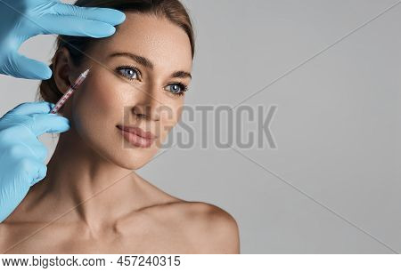 Beautiful Woman During Facial Mesotherapy For Smoothing Of Mimic Wrinkles Around Eyes With Beauticia
