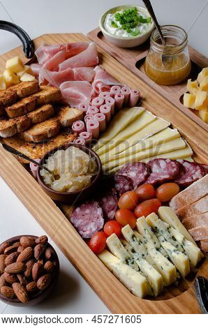 Delicious Charcuterie Board With Snacks Cheese, Toast, Ham, Blue Cheese, Almonds, Caramelized Onions