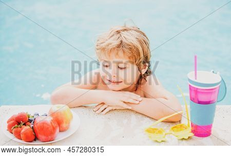Little Boy With Fresh Cocktail And Fruits On Watter Pool In The Summer Day. Kid In Swimming Pool Rel