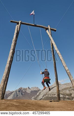 Huge Swing Surrounded By Mountains In Riano Village. Spain