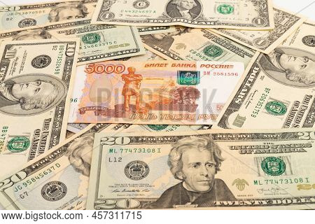 Russian 5000 Rubles And 100 Dollars Close Up, Concept Of Finance Is Laid Out As A Background. Ruble 