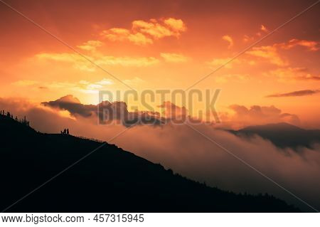 Beautiful Sunset Over The Silhouette Of The Mountain With Clouds. Dramatic Sunset Sky Cloudscape. Fr