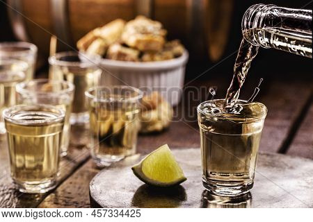 Glass Of Cachaça, Pinga, Cana Or Caninha Is The Sugar Cane Brandy, Typical Drink From Brazil, Drops 