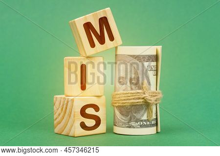Business Concept. On A Green Surface, Dollars And Cubes With The Inscription - Mis