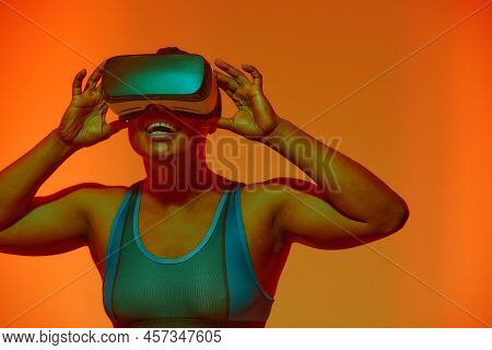 Modern African Black Woman With Short Hiar In Sport Top Wearing Glasses Of Virtual Reality On Yellow