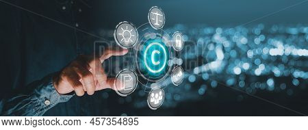Copyright Or Patent Concept, Business Person Hand Holding Vr Screen Copyright Icon With Blue Bokeh B