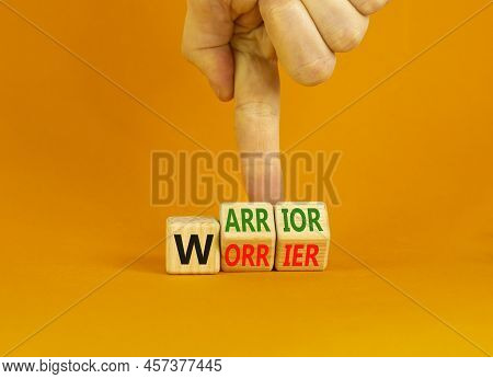 Be Warrior Not Worrier Symbol. Concept Words Warrior And Worrier On Wooden Cubes. Businessman Hand. 