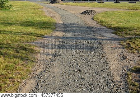 Construction Of A Threshing Gravel Sidewalk, Installation Of A Steel Strip As A Curb Path. Between T