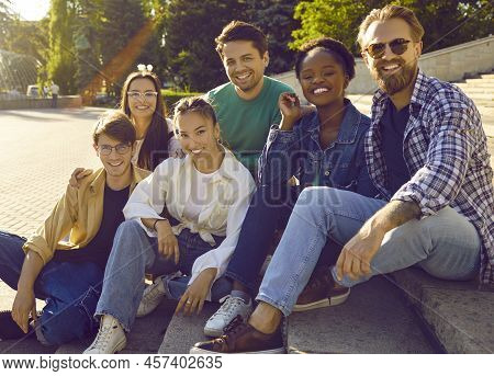 Portrait Of Carefree Cheerful And Friendly Multiracial Men And Women On Background Of City Park.