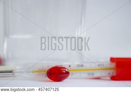 Thermometer, Pills On A Light Background Pharmacy