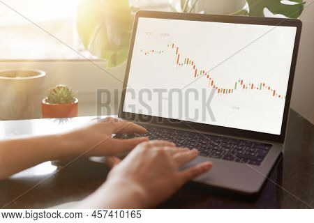 Female Hands Writing Down Numbers From Laptop. Investment Analysis, Trading Concept. Technology, Dig