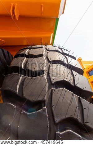 Huge Rear Wheels Of Dump Truck At Unusual Angle Closeup.