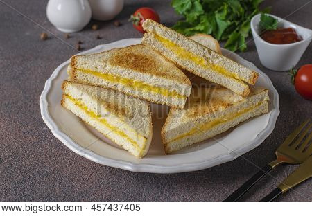 Sandwiches With Egg And Cheese Fried In Pan Served With Tomato Sauce For Breakfast