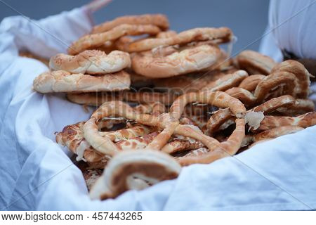 Selling Pretzels From A Basket Street Vendor
