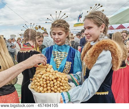 Yekaterinburg, Russia - June 25. 2022: Cute Smiling Asian Girls In National Festive Clothes Holding 