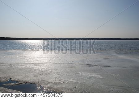 A Wide River Is Being Freed From Ice. Spring Day Light Blue Sky, River Flood With Blue Water. At The