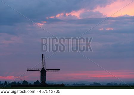 This Beautiful Mountain Mill Is Located In Wannegem-lede Belgium, With The Rise Of The Sun And  Clou