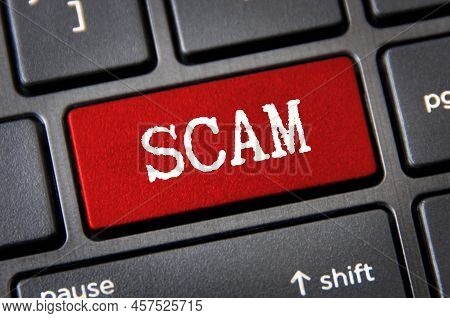 Scam Text On Red Laptop Tab. Online Security Concept