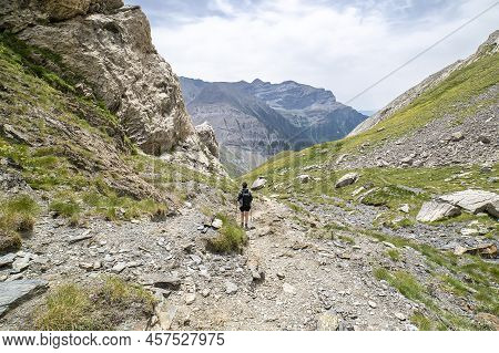Female Hiker Descending From Lake 