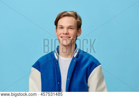 Happy Joyful Young Man With Red Hair Stands In A Fashionable Blue Jacket And Smiles Broadly Showing 