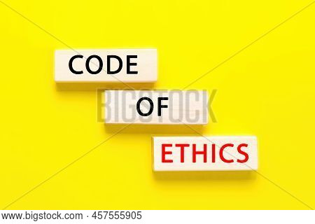 Code Of Ethics Symbol. Concept Words Code Of Ethics On Wooden Blocks On Yellow Background. Business 