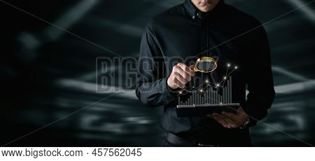 Concept Of Financial Market Analytics. Businessman Examine Financial Growth Chart With A Magnifying 