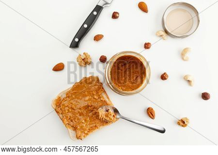 Bread With Peanut Butter. Jar Of Peanut Butter. Jar Lid, Spoon, Knife And Different Types Of Nuts. C