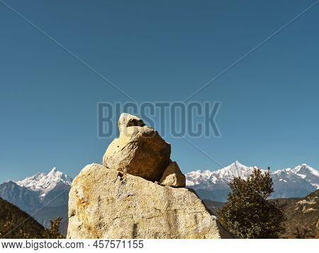Huge Prayer Stone With Meili Snow Mountain In Background In China's Yunnan Province