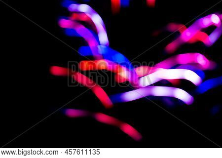 Colorful Bright Neon Searchlight Light On Black.