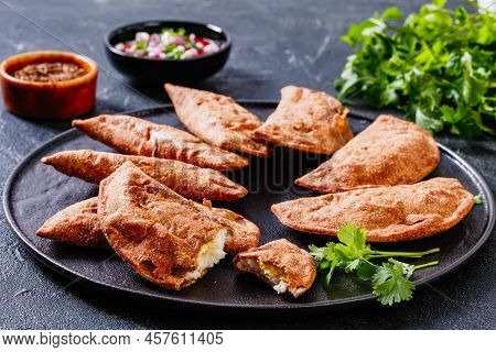 Empanadas, Hand Pies With Hard Boiled Egg Fillings On Black Platter On Concrete Table, Horizontal Vi