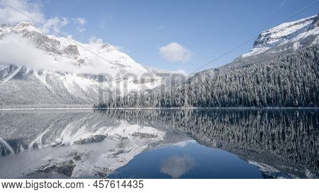 Still Alpine Lake Reflecting Its Winter Surroundings Like A Mirror, Wide, Yoho N. Park, Canada.