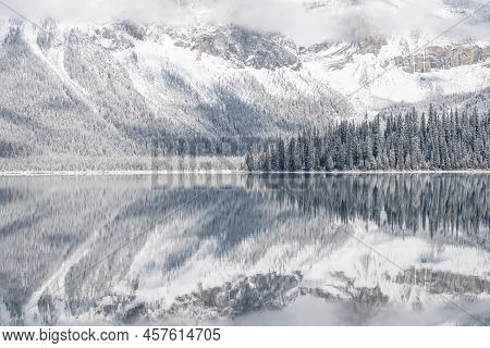 Still Alpine Lake Reflecting Its Winter Surroundings Like A Mirror, Narrow, Yoho N. Park, Canada.