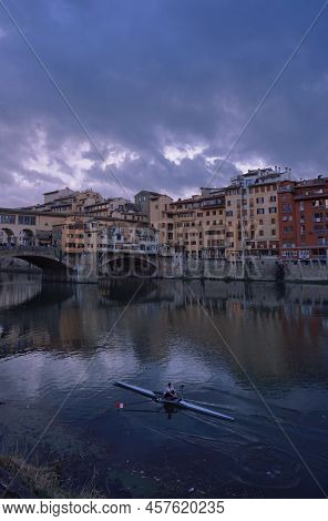 A Man Was Paddling A Canoe In Florence.