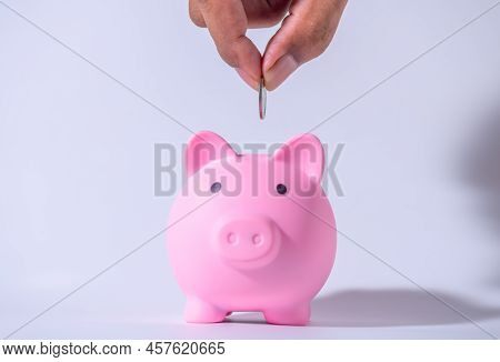Save Money And Account Banking For Finance Concept, Hand With Piggy Bank And Coin On Blurred Backgro