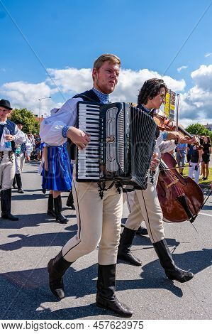 A Man In Folk Costume Plays The Accordion In The Procession